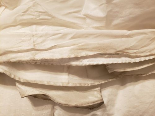 The hem is dirty, particularly the inside of the hem
